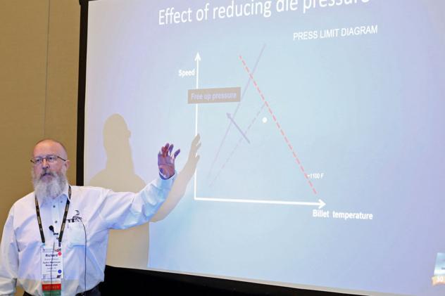 Man pointing to a screen with graphics